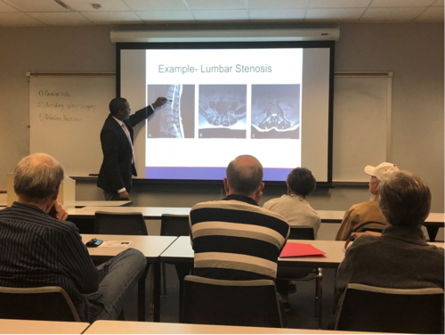 Dr. Barkoh giving a lecture on minimally invasive spine surgery at Lonestar College Academy for Lifelong Learning.