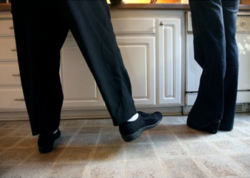 Jane Glenn Haas does leg exercises with a physical therapist at her home in Irvine logo