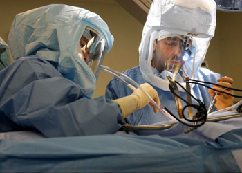 Dr. Robert Gorab, right, performs surgery on Jane Glenn logo