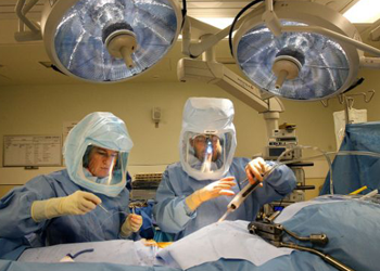 Dr. Robert Gorab, right, performs hip replacement surgery logo