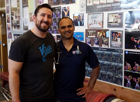 Dr. Misra in the gym working with US Olympic Weightlifter he attended to the care of while at the USOC Headquarters together