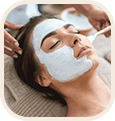 A woman relaxes as a facial mask is applied, emphasizing self-care.
