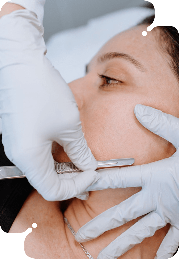 A woman getting dermaplaning in a clinical hospital room.