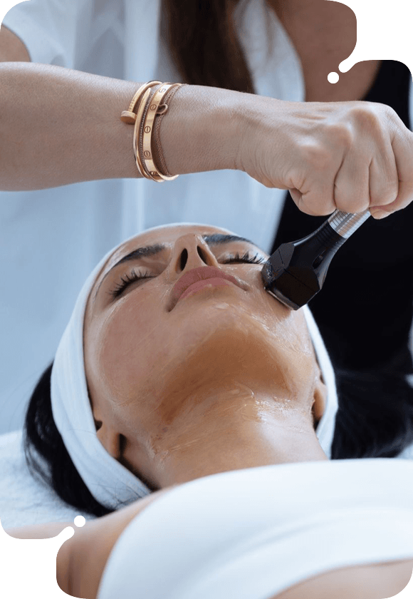 A woman with a mask receiving No-Needle MesoTherapy.