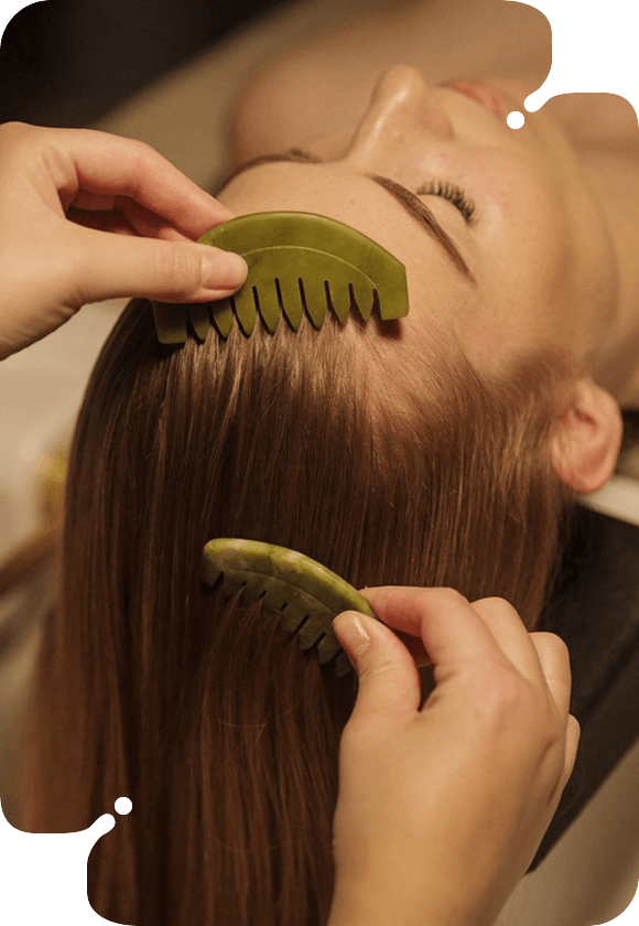 A woman getting a scalp treatment