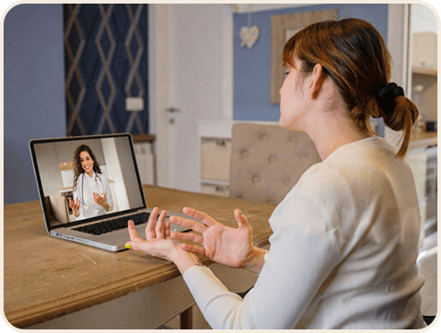 A woman having a virtual consultation with a doctor on her laptop.