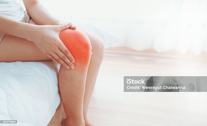 Picture of Woman-hands-touching-her-knee-area-bone-pain-trauma-or-torn-ligament-in-the-knee
