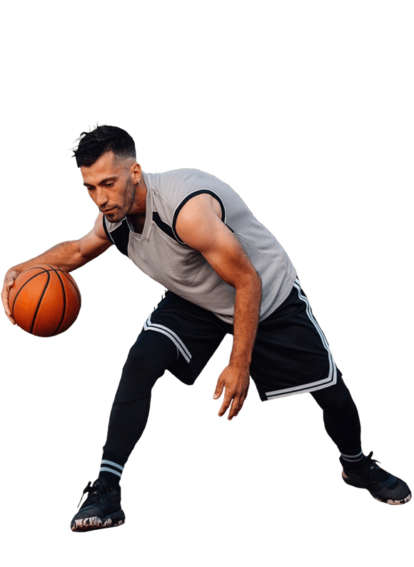A man in gray and black grips a basketball, representing confidence from personalized care.