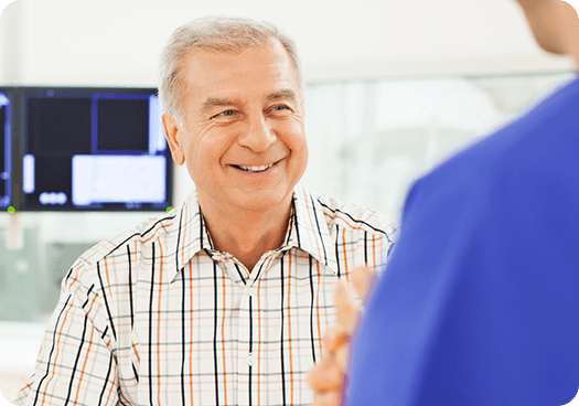 A man consults a doctor about orthopaedic assessment options in a hospital.