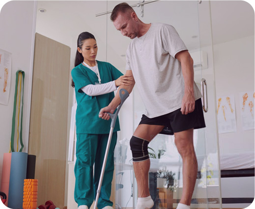 Physical therapist assisting patient with rehabilitation